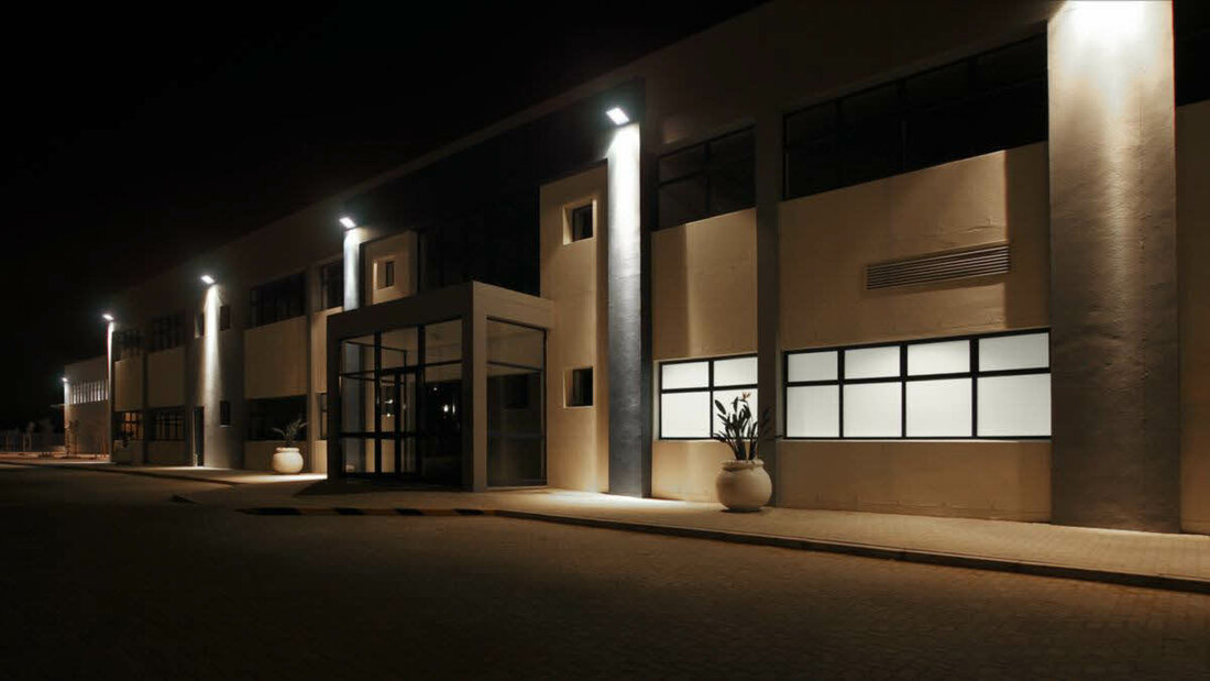 Ein modernes Gebäude wird bei Nacht durch LED-Fluter angestrahlt.
